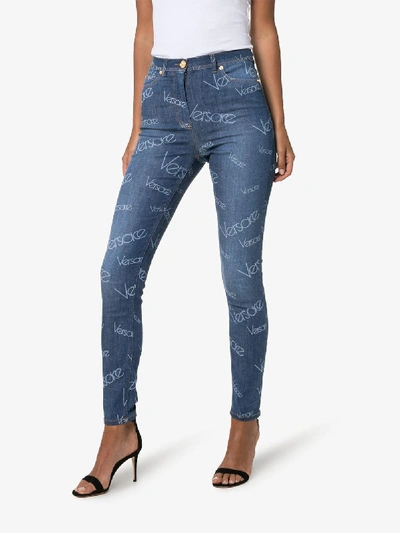 Shop Versace Washed Logo Effect Skinny Jeans In Blue