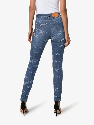 Shop Versace Washed Logo Effect Skinny Jeans In Blue