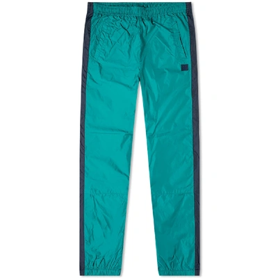 Shop Acne Studios Phoenix Face Track Pants In Green