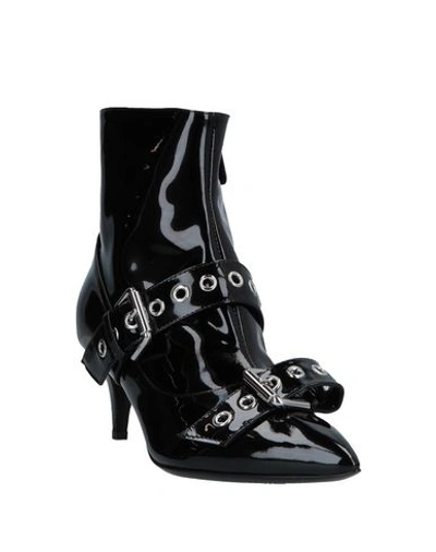 Shop Moschino Ankle Boots In Black