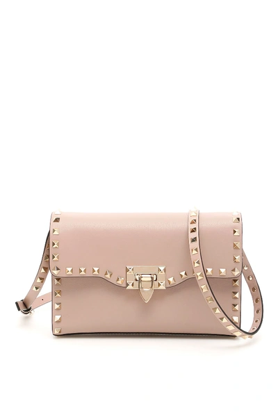 Shop Valentino Small Rockstud Crossbody Bag In Poudre (pink)