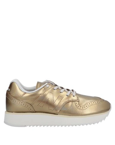 Shop New Balance Sneakers In Gold