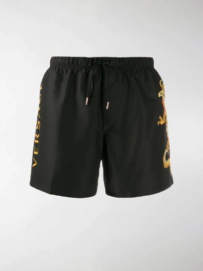 Shop Versace Dragon Motif Swim Shorts In Black