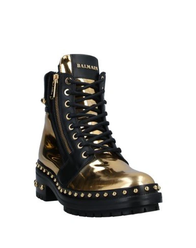 Shop Balmain Ankle Boots In Gold