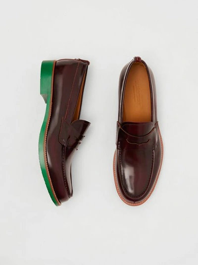 Shop Burberry D-ring Detail Contrast Sole Leather Loafers In Bordeaux/green