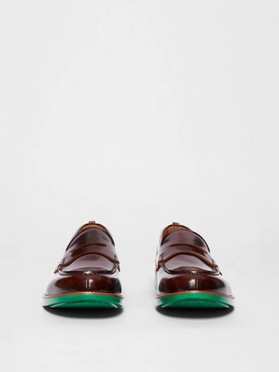 Shop Burberry D-ring Detail Contrast Sole Leather Loafers In Bordeaux/green