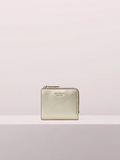 Shop Kate Spade Sylvia Small Bifold Wallet In Pale Gold