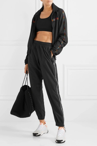 Shop Adam Selman Sport Crystal-embellished Shell Track Pants In Black