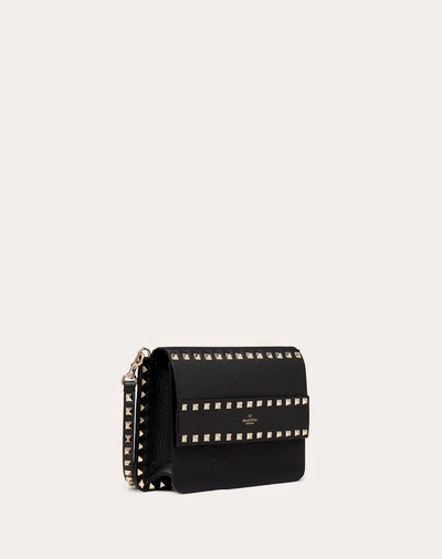 Shop Valentino Garavani Small Rockstud Grainy Leather Crossbody Bag In Black