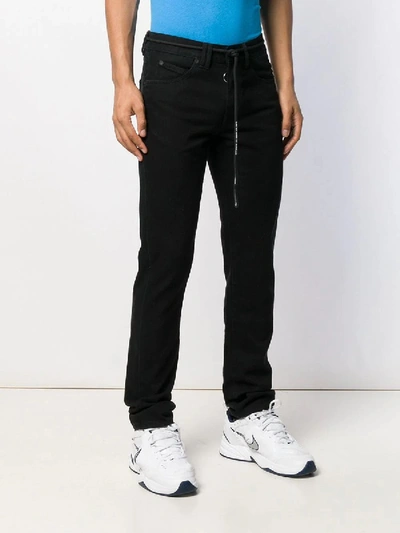 Shop Off-white Embroidered Arrows Logo Jeans