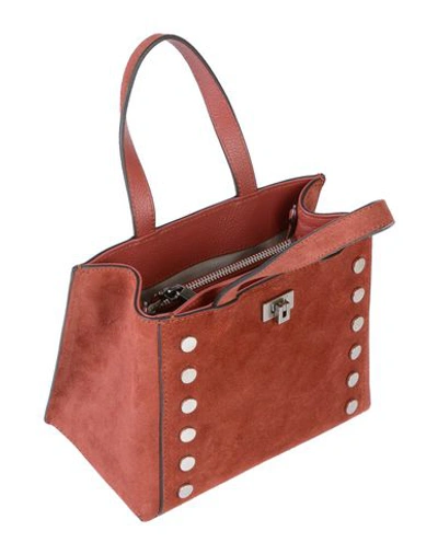Shop Coccinelle Handbag In Brick Red