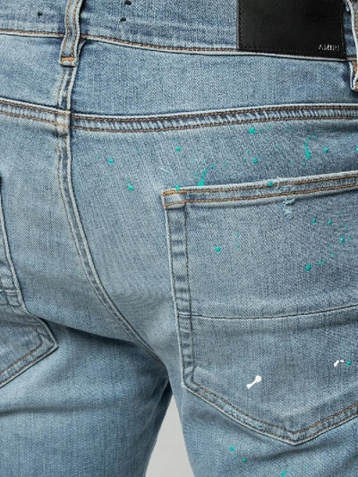 Shop Amiri Paint Splatter Distressed Jeans Indigo