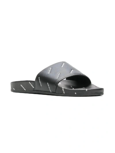 Shop Balenciaga Logo Embossed Slides In Black