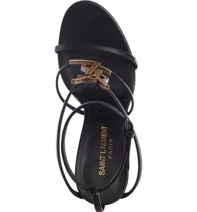 Shop Saint Laurent Cassandra Ysl Strappy Sandal In Black/ Gold