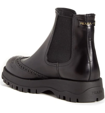 Shop Prada Lug Sole Chelsea Boot In Black Leather