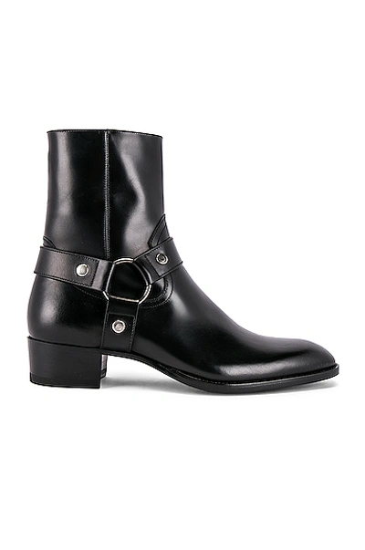 Shop Saint Laurent Wyatt Leather Harness Boots In Black