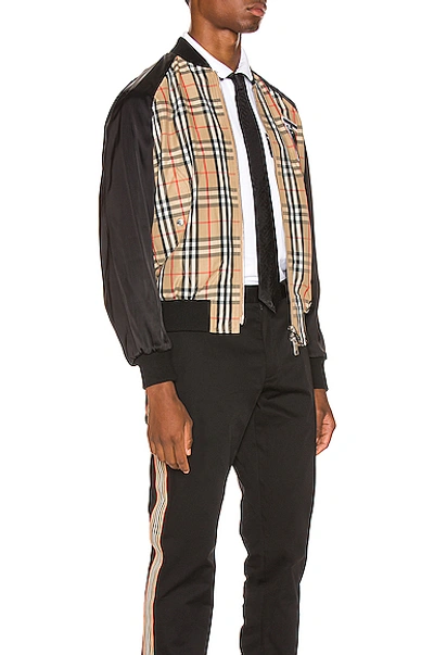 Shop Burberry Harlington Varsity Jacket In Black,neutral,plaid In Archive Beige