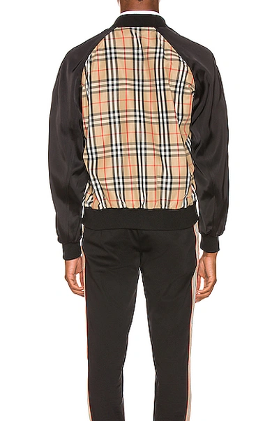 Shop Burberry Harlington Varsity Jacket In Black,neutral,plaid In Archive Beige