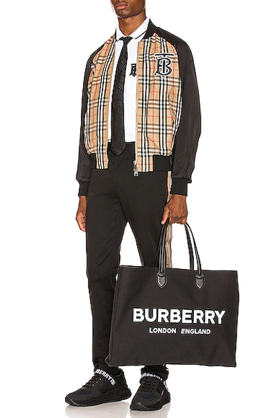 Shop Burberry Harlington Varsity Jacket In Black,neutral,plaid In Archive Beige