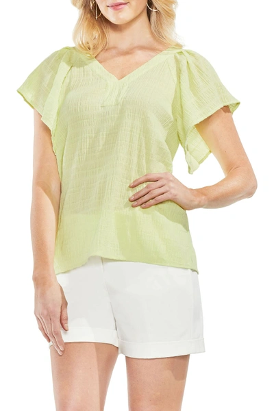 Shop Vince Camuto Flutter Sleeve Smocked Top In Soft Kiwi