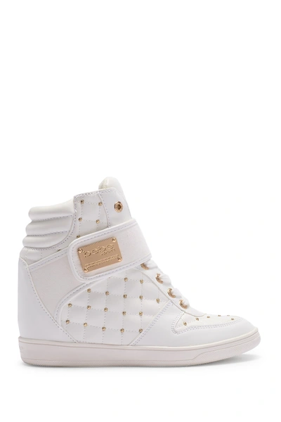 Shop Bebe Studded Hi-top Wedge Sneaker In White Faux