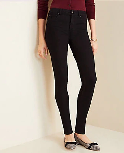 Shop Ann Taylor Mid Rise Skinny Jeans In Jet Black Wash