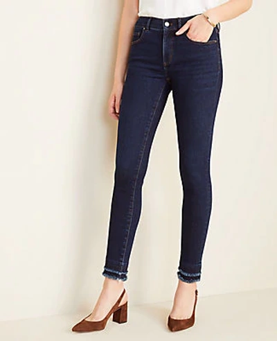 Shop Ann Taylor Frayed Performance Stretch Skinny Jeans In Classic Mid Wash In Blue