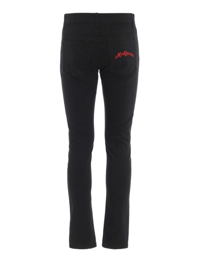 Shop Alexander Mcqueen Total Black Jeans With Red Embroidery