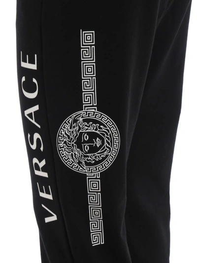 Shop Versace Logo And Medusa Print Cotton Joggers In Black