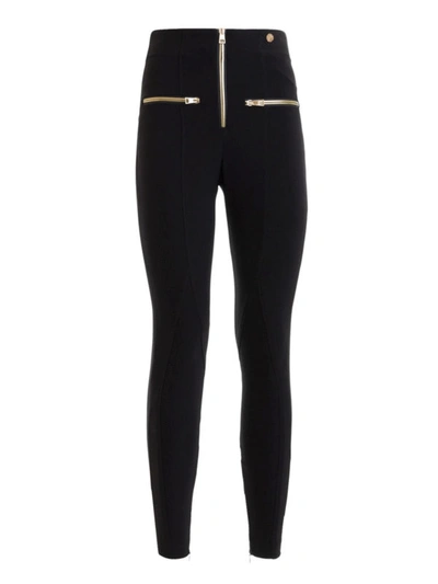 Shop Versace Stretch Tight Pants With Gold-tone Zippers In Black