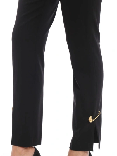 Shop Versace Wool Blend Gold-tone Brooch Trousers In Black