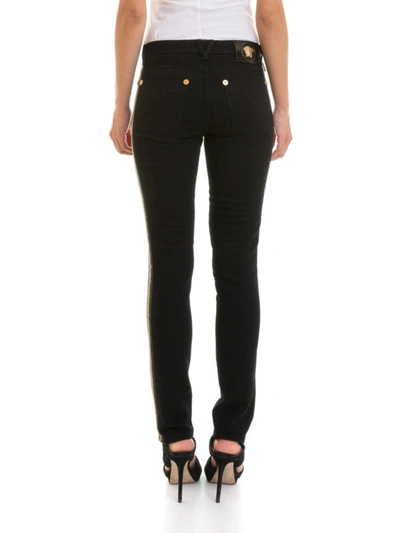 Shop Versace Greek Side Band Slim Fitting Jeans In Black