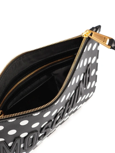Shop Moschino Logo Lettering Polka Leather Clutch In Black