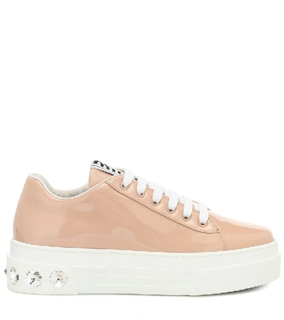 Shop Miu Miu Embellished Patent Leather Sneakers In Beige