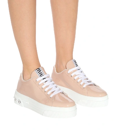 Shop Miu Miu Embellished Patent Leather Sneakers In Beige