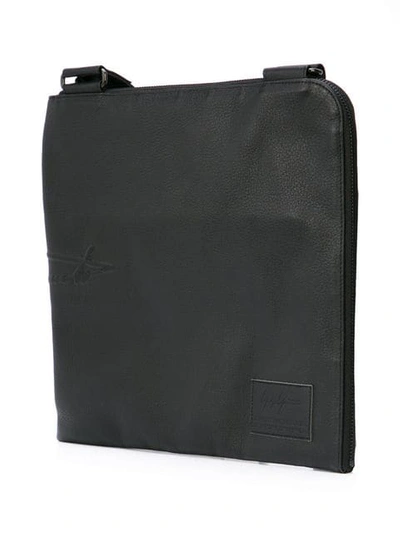 Shop Yohji Yamamoto Embossed Logo Messenger Bag In Black