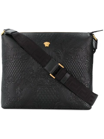Shop Versace Embossed Messenger Bag In Black