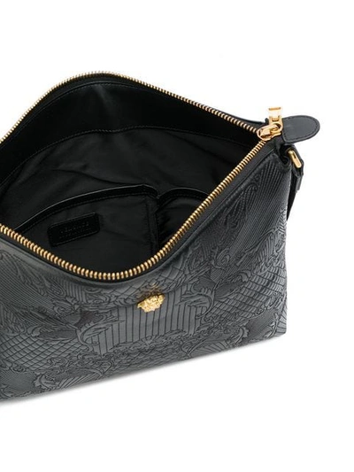 Shop Versace Embossed Messenger Bag In Black