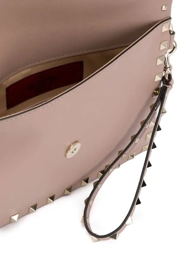 Shop Valentino Rockstud Leather Clutch Bag In Neutrals