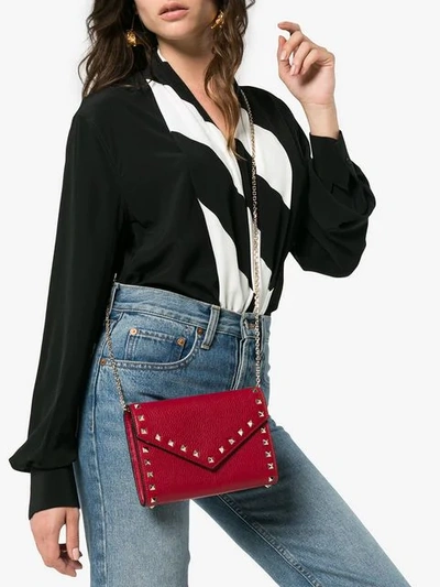 Shop Valentino Garavani Rockstud Clutch In Red