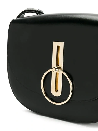 Shop Nina Ricci Disc Buckle Rounded Shoulder Bag In Black