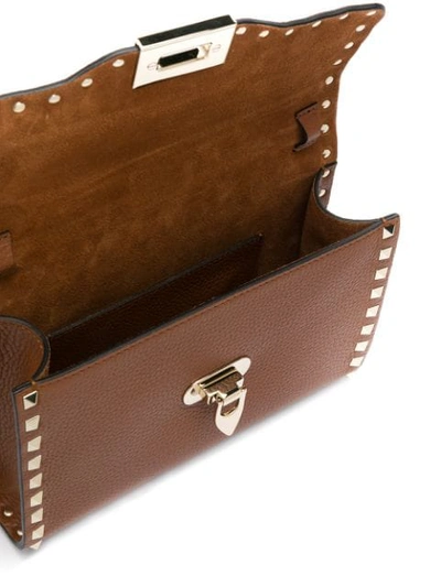 Shop Valentino Garavani Small Rockstud Crossbody Bag In Brown