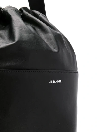 Shop Jil Sander Embossed Logo Bucket Bag In Black