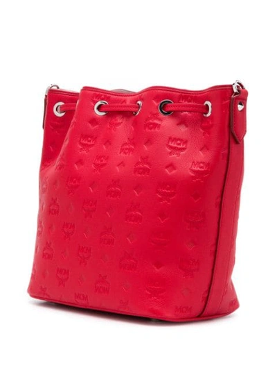 Shop Mcm Embossed Logo Bucket Bag In Red