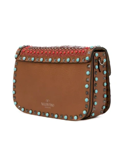 Shop Valentino Garavani Rockstud Rolling Shoulder Bag In Brown