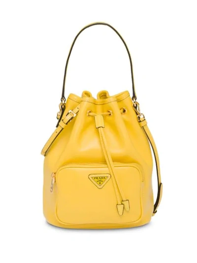 Shop Prada Logo Bucket Bag In Yellow