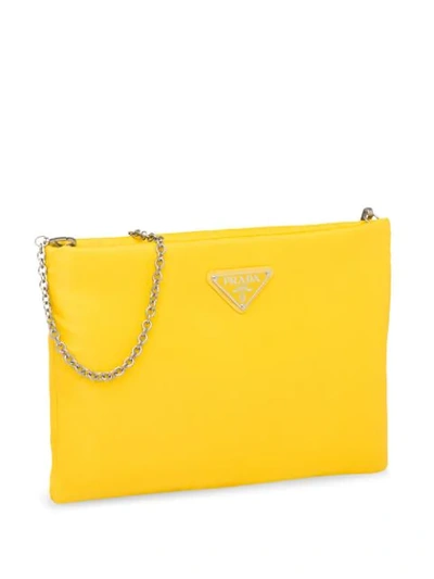 Shop Prada Padded Clutch Bag In Yellow