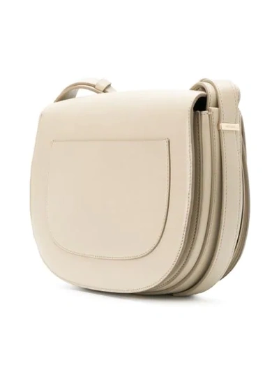 Shop Nina Ricci Disc Buckle Rounded Shoulder Bag In Neutrals