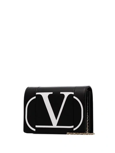Shop Valentino Garavani Logo Print Leather Crossbody Bag In Black