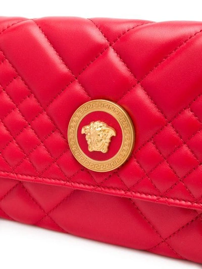 Shop Versace Quilted Chain Wallet Bag In Red